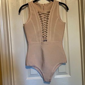 Nude bandage laced cleavage closure body suit